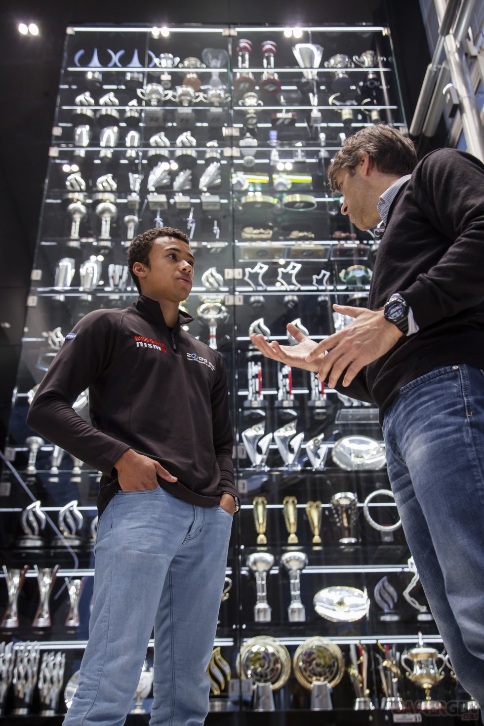 Jann Mardenborough and Andy Damerum in front of Infiniti Red Bull Racing's impressive trophy collection